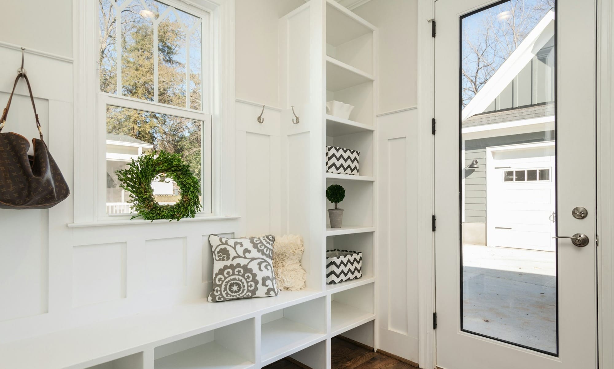 gray and white floral throw pillow beside rack inside room